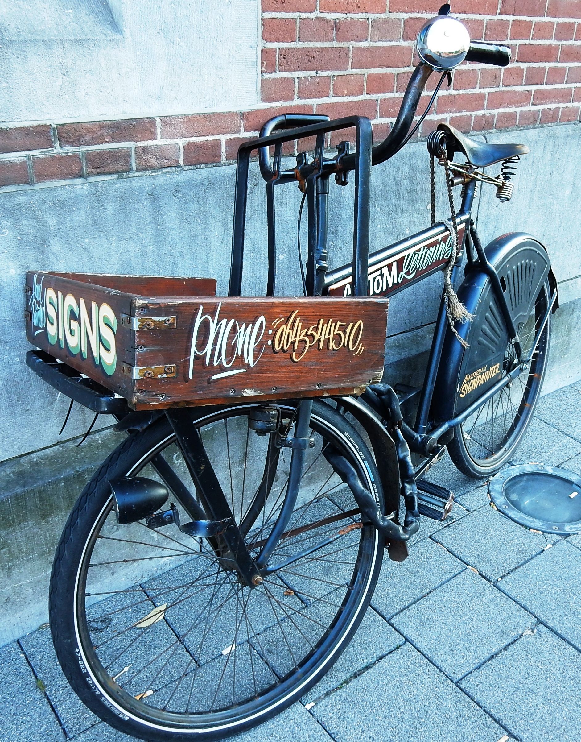 Bicycle with hand-painted lettering advertising sign painters