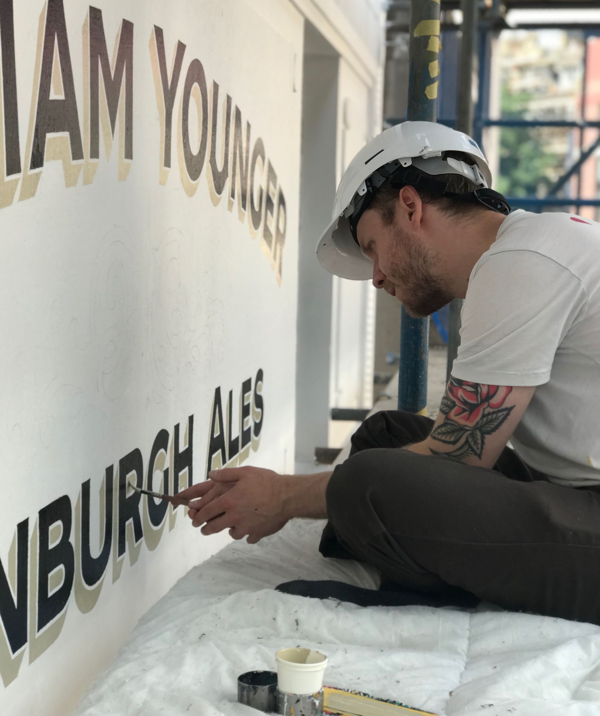 Sign painter working with a brush