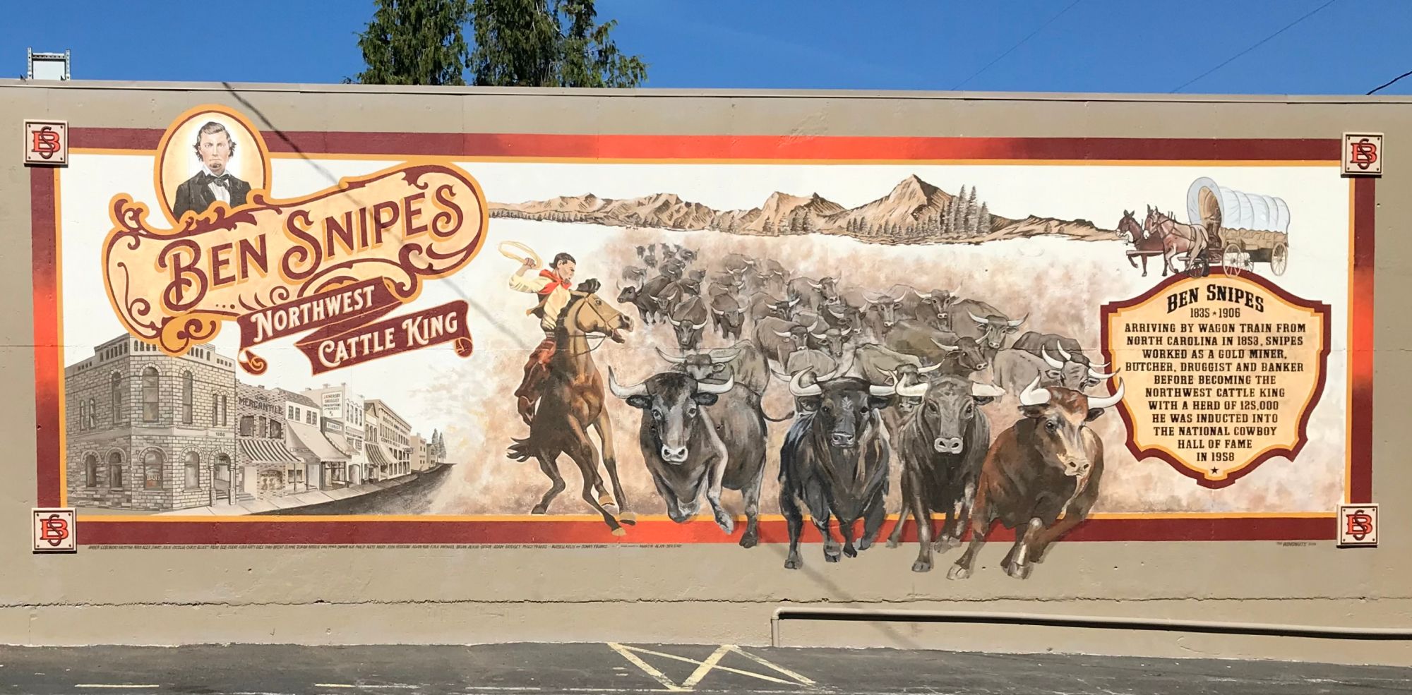 Mural showing a cowboy herding cattle.
