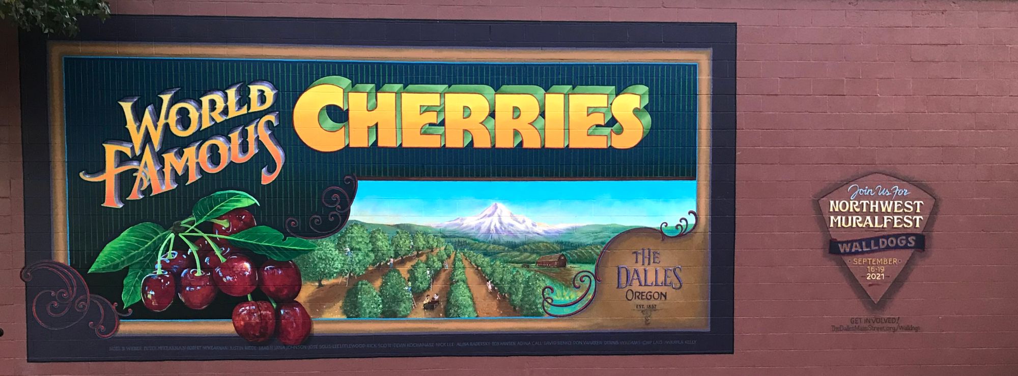 'World Famous Cherries' and a picture of people working in a cherry orchard.