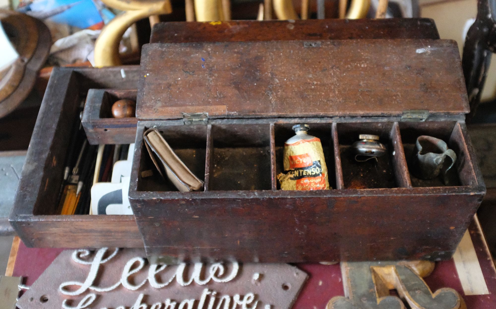 Wooden box with compartments and drawers.