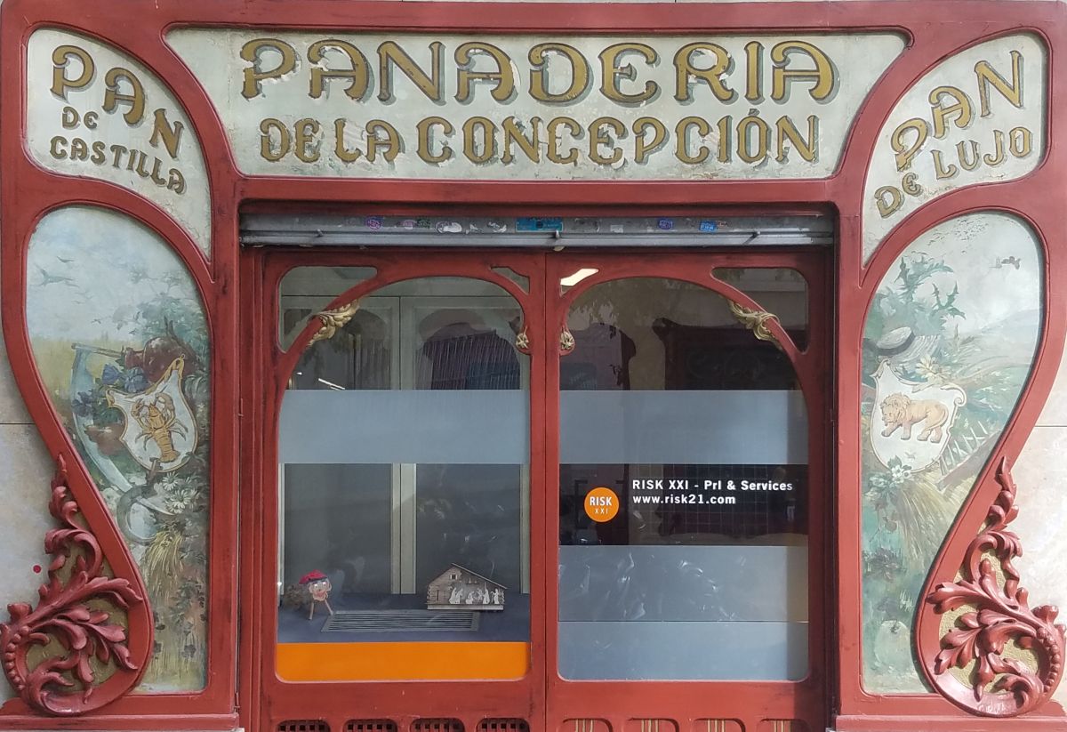 Shopfront with carved wood and gilded and painted glass panels.