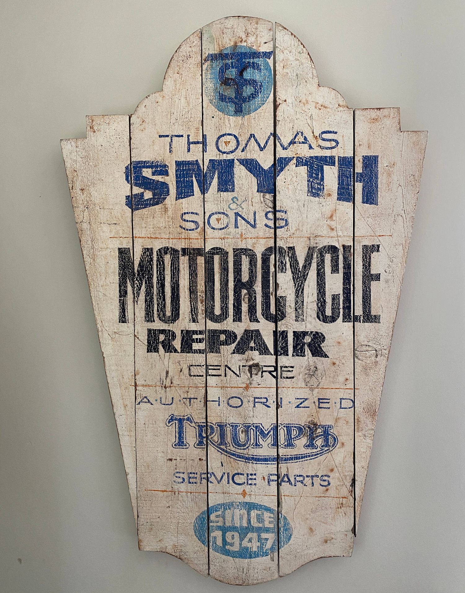 Hand-painted and faux-aged panel for a motorcycle repair centre.