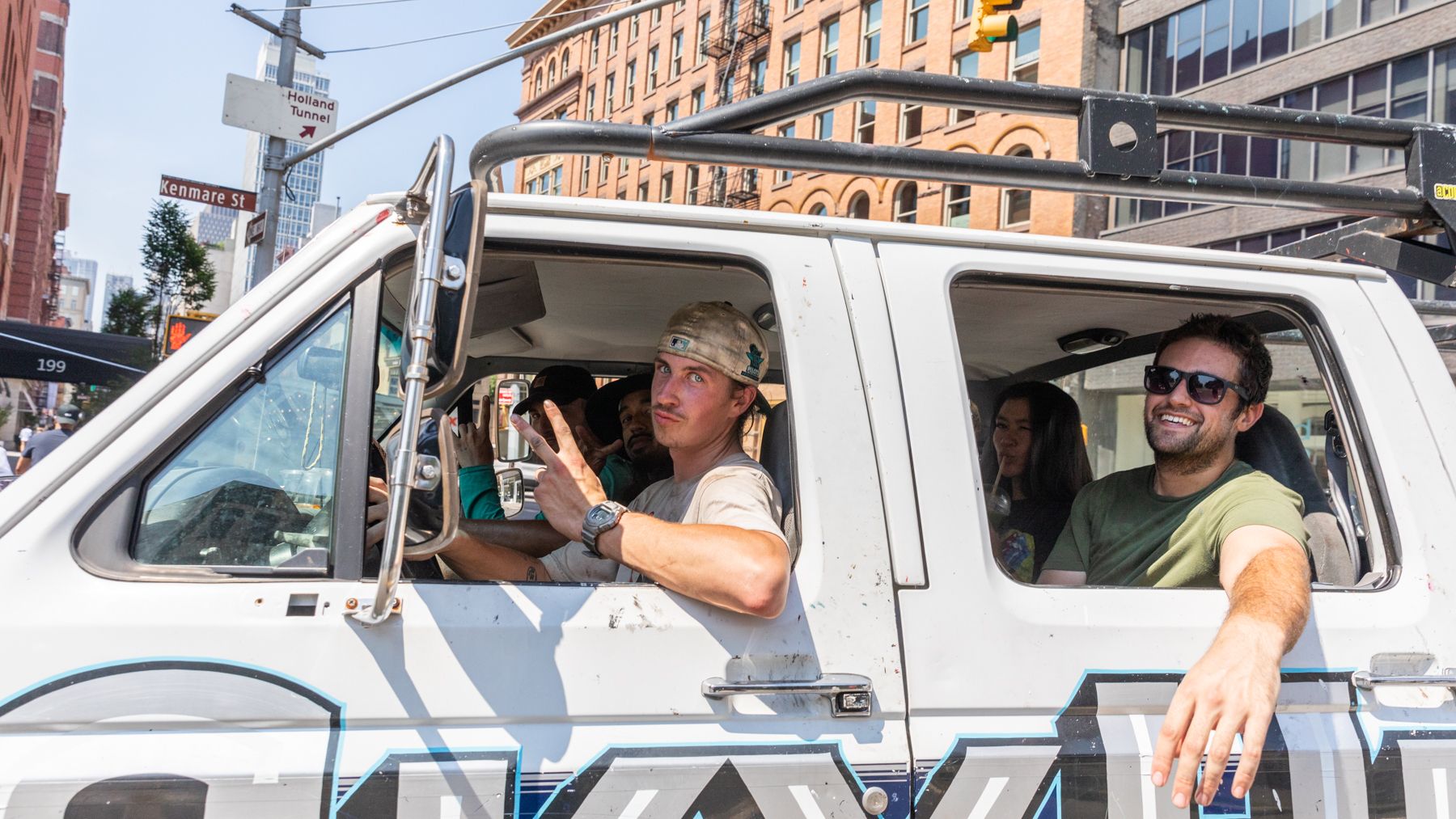 People looking out the windows of a truck.