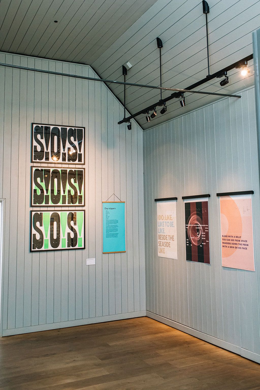 Work hanging on gallery walls, including three framed letterpress prints.