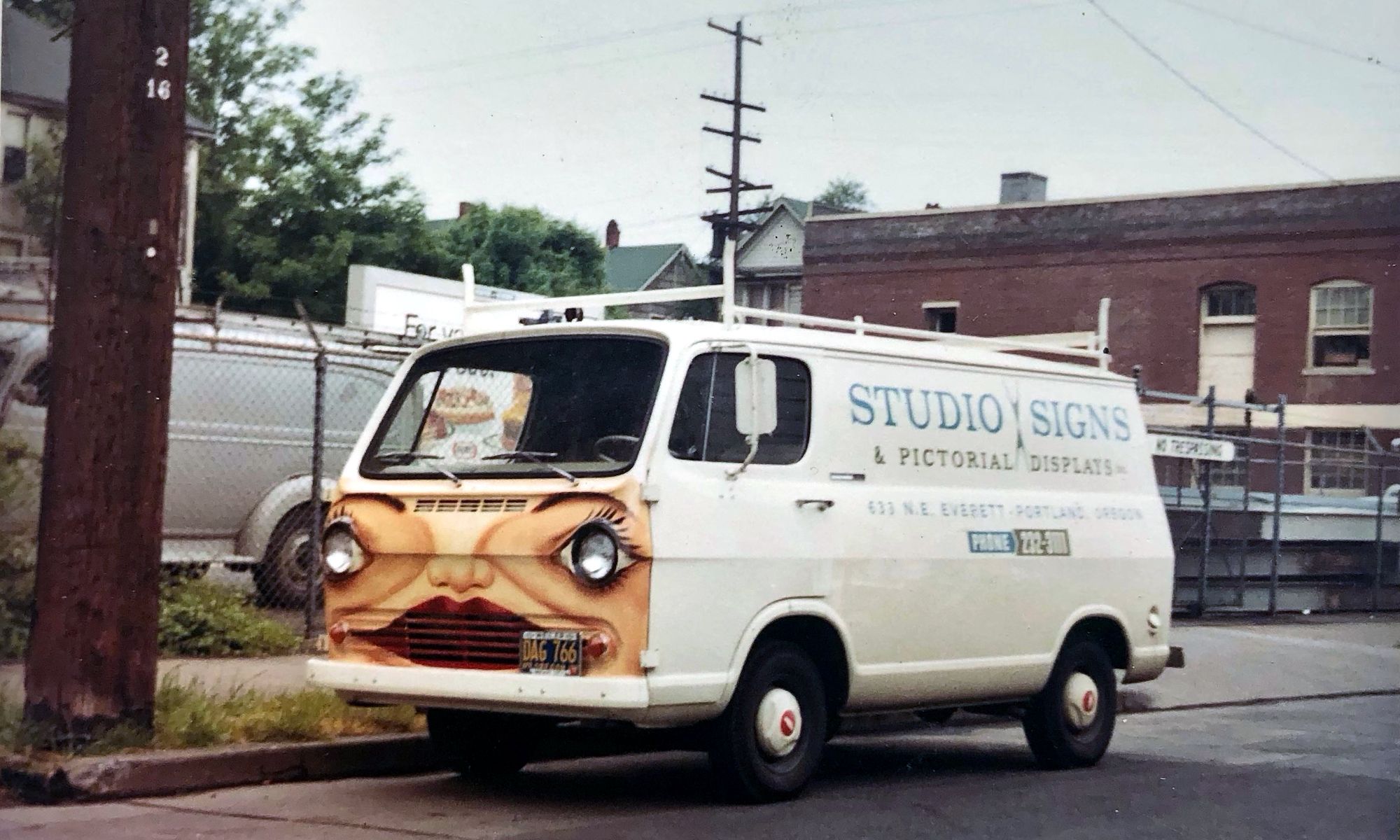 Hand-lettered and illustrated van parked on a street.