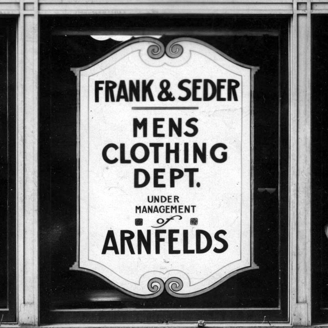 Hand-painted window with a simple decorative border and lettering advertising the Frank & Seder Men's Clothing Department.