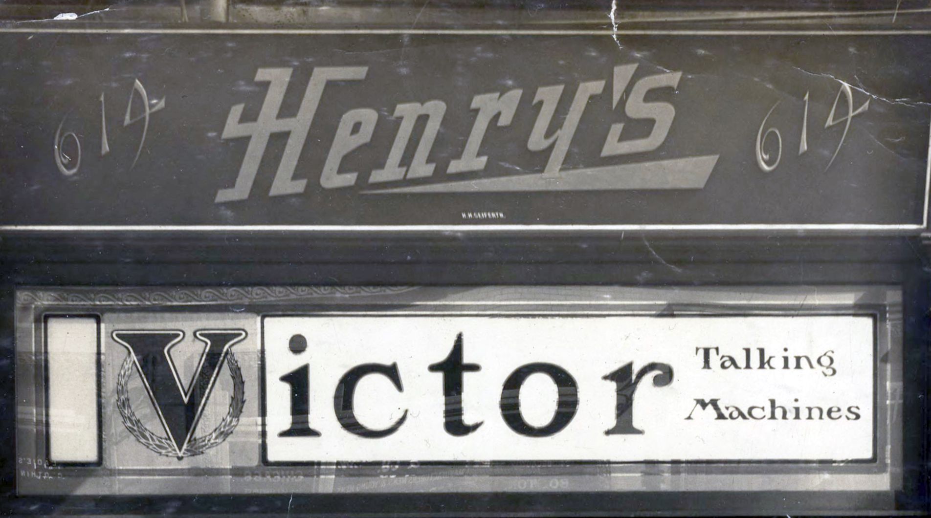 Shop front reading "Henry's" above a gilded and hand-painted glass panel for "Victor Talking Machines".