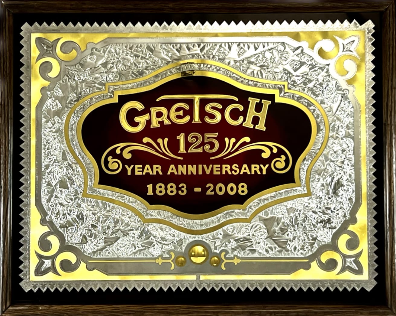 Decorative glass panel with gold, silver and red paint. It reads "Gretsch 125 year anniversary, 1883–2008".