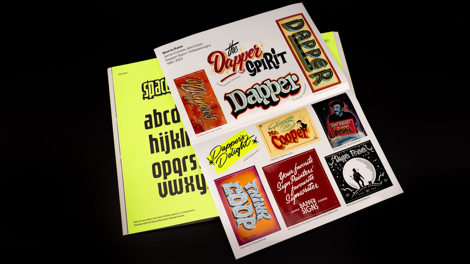 A magazine opened to the centre spread which has an alphabet in black set on a bright fluorescent background. Laid over the top of this is a sheet of ten stickers, each of which pays tribute to Dapper Signs.