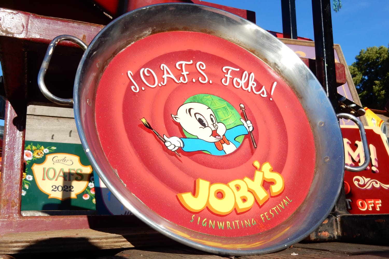 A paella dish with a take on the Loony Toons closing screen that shows Porky Pig holding a mahl stick and sign painting brush. The lettering above reads 'I.O.A.F.S. Folks!' and below 'Joby's Signwriting Festival'.