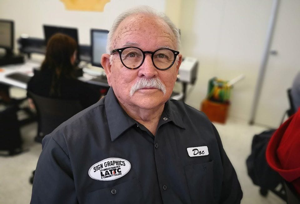 Man in glasses and a work uniform.