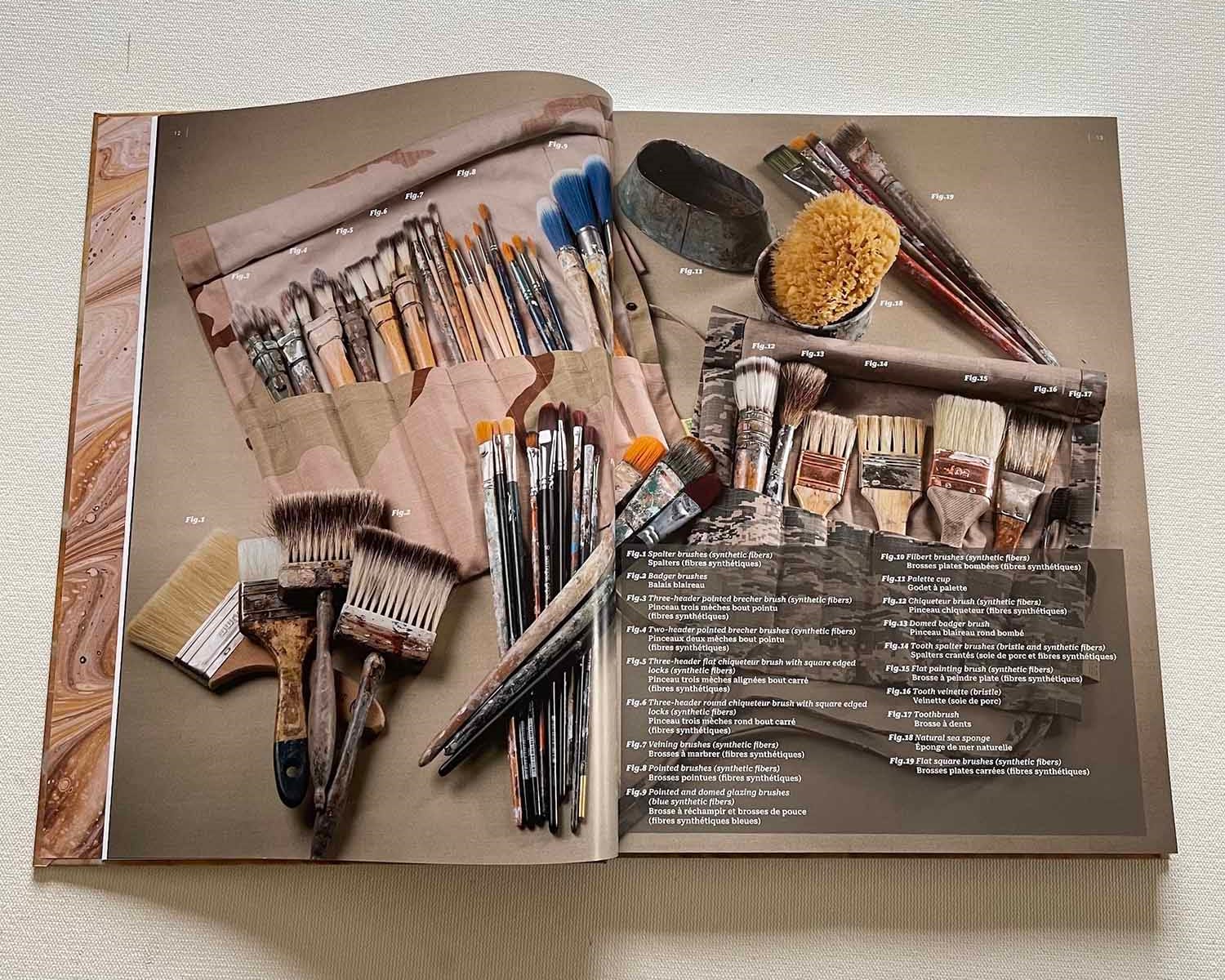 Book laid open on a spread shwoing a variety of brushes.