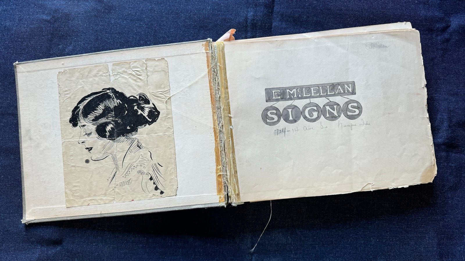 Book opened to the first page. On the left is a black and white illustration of a woman's head and shoulders in profile. On the right is a piece of lettering in the style of a sign that reads "E. McLellan Signs".