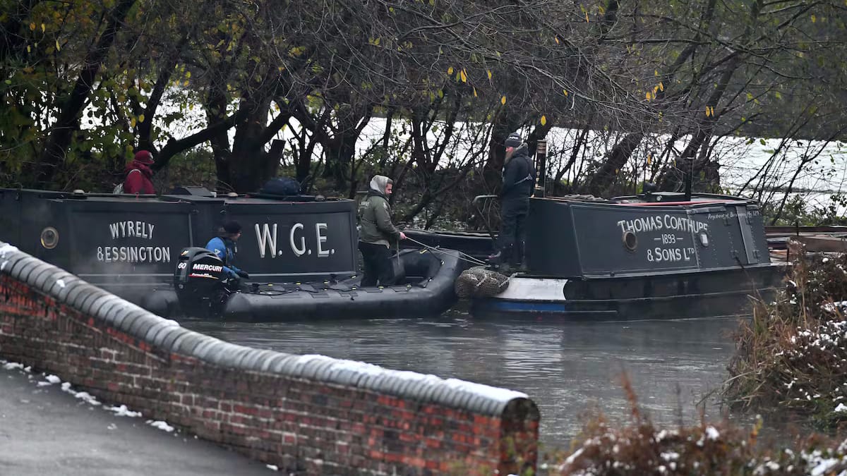 Two canalboats with hand-painted lettering on their sides.