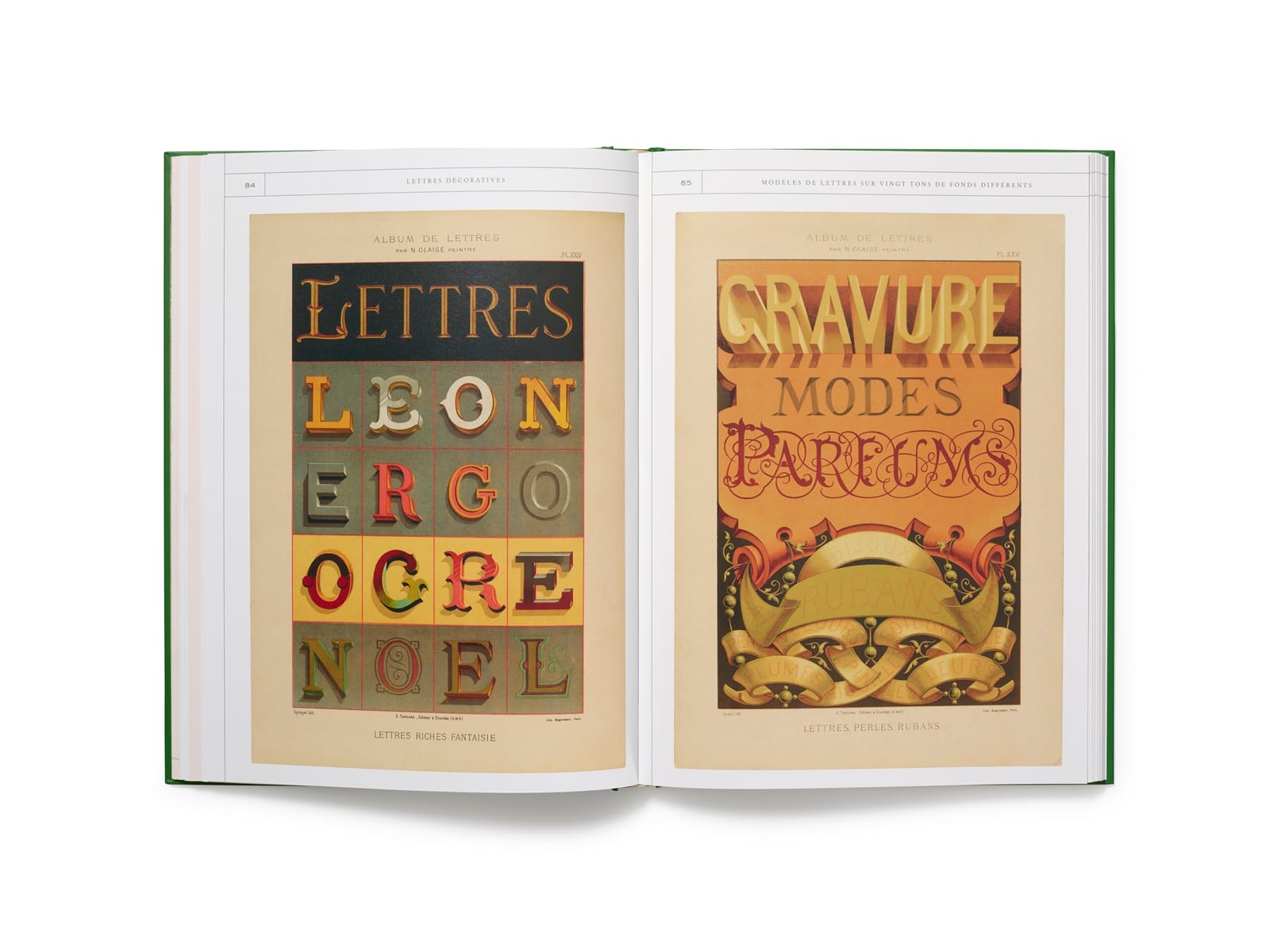 Photo of a book laid out to show a spread. The left page has a series of letters rendered in different colours and lettering effects with the title "Lettres". The right side has a highly decorated painted panel with ribbons dominating the bottom half and the three words of "Gravure, Modes, Parfums" rendered in different lettering styles.
