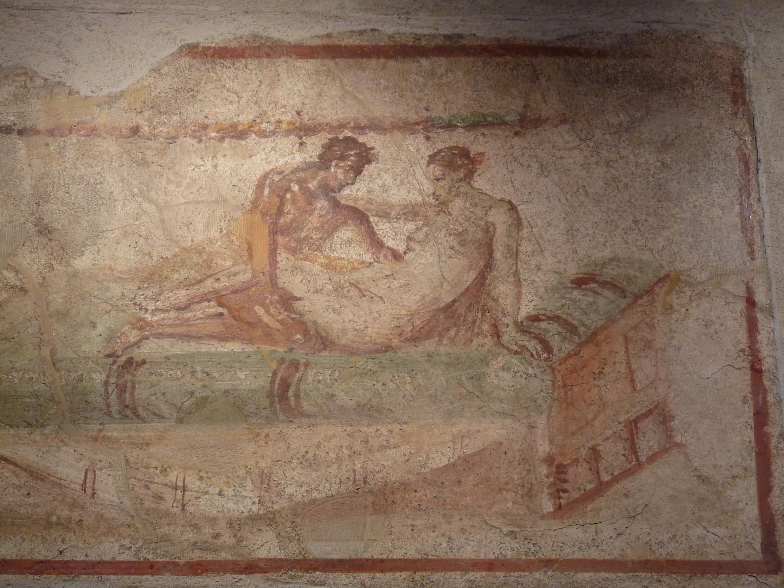 Man holding a naked women in a reclining position.