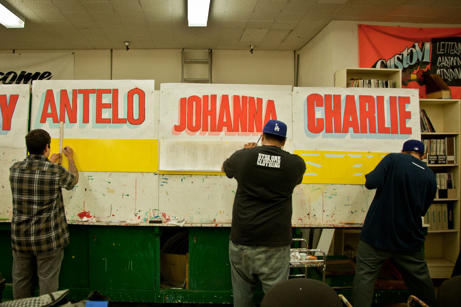 Students at easels in a sign painting class.