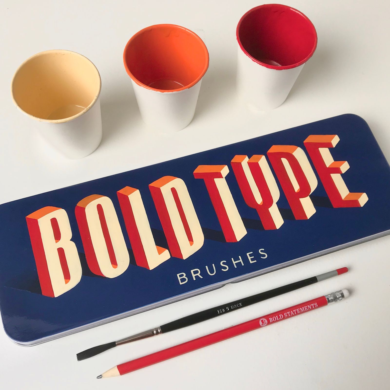 Hand-painted sign with three-dimensional letters reading 'Bold Type Brushes'