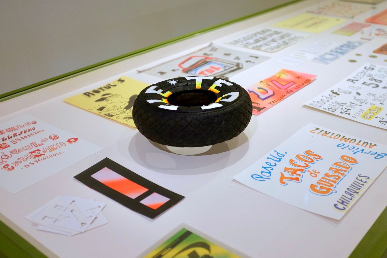 Table top with array of hand-lettered and hand-painted exhibits.