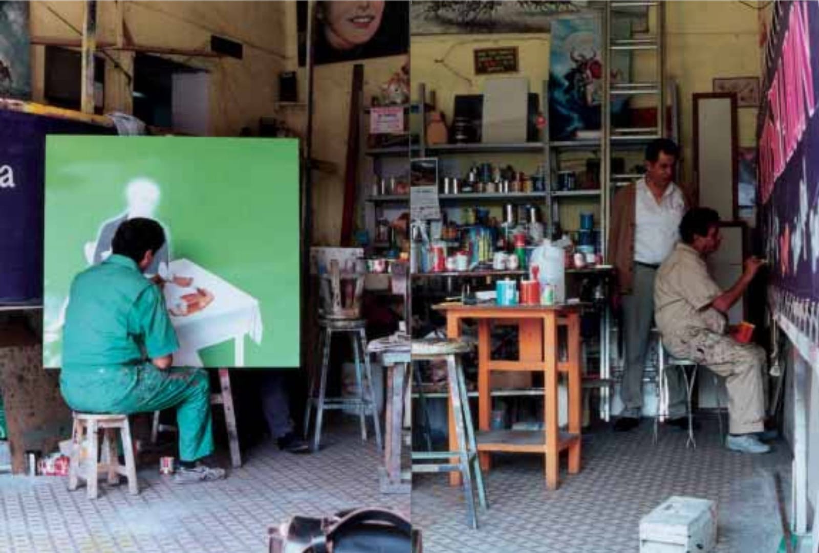Sign shop/artist studio with men at work on paintings, and various stools, tables, and shelves storing materials.