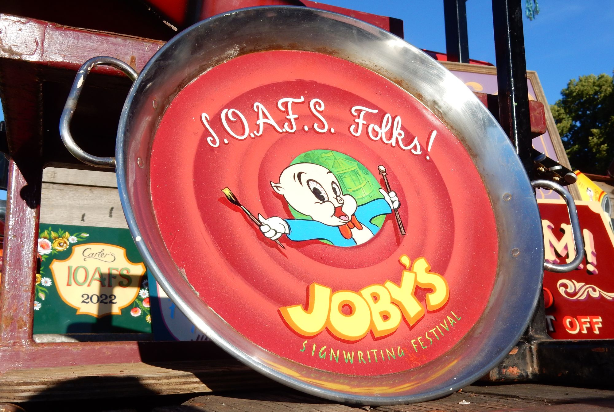 Hand-painted paella dish with Looney Toons style illustration and lettering.