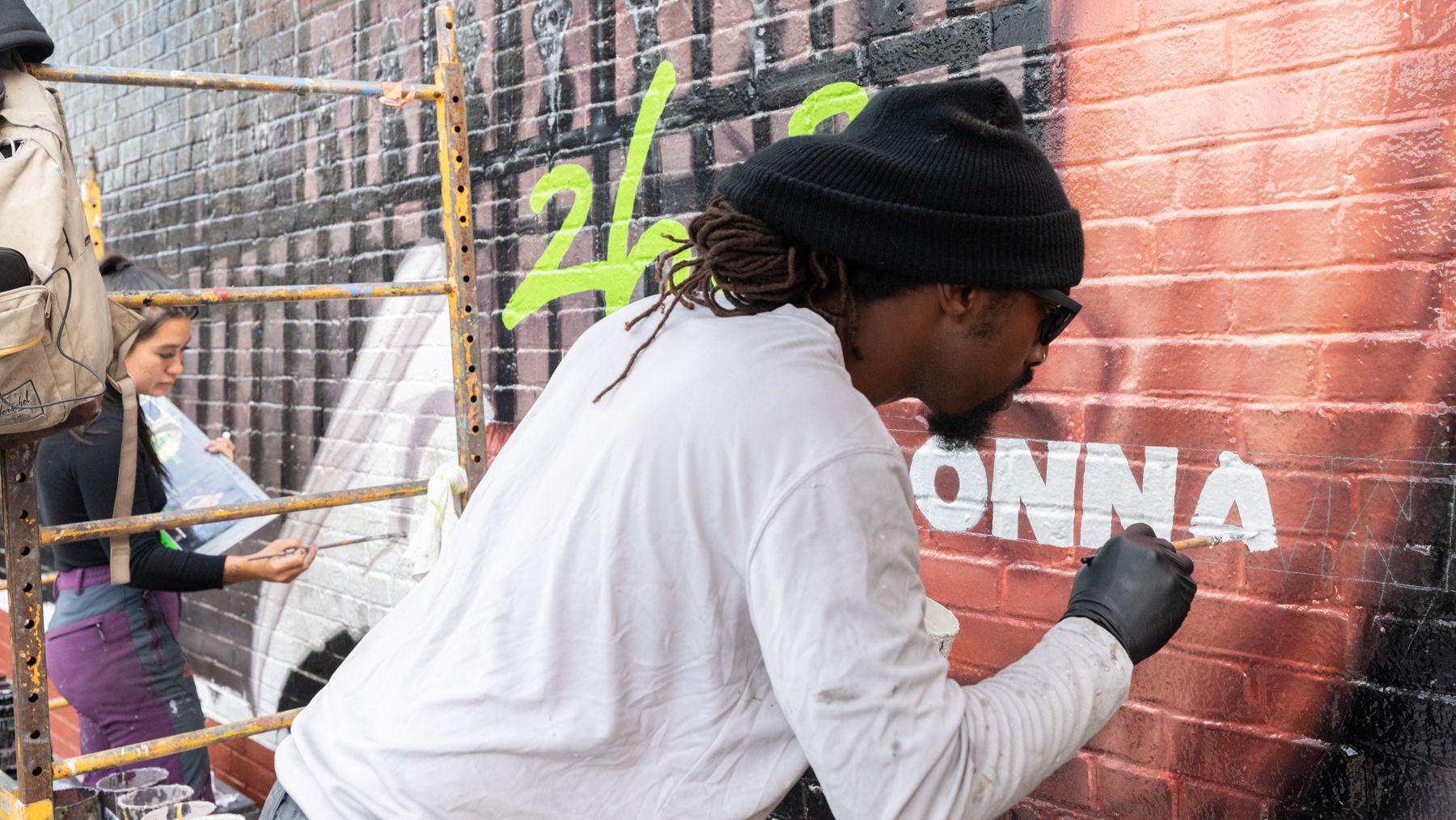 Painters painting an advertising mural.