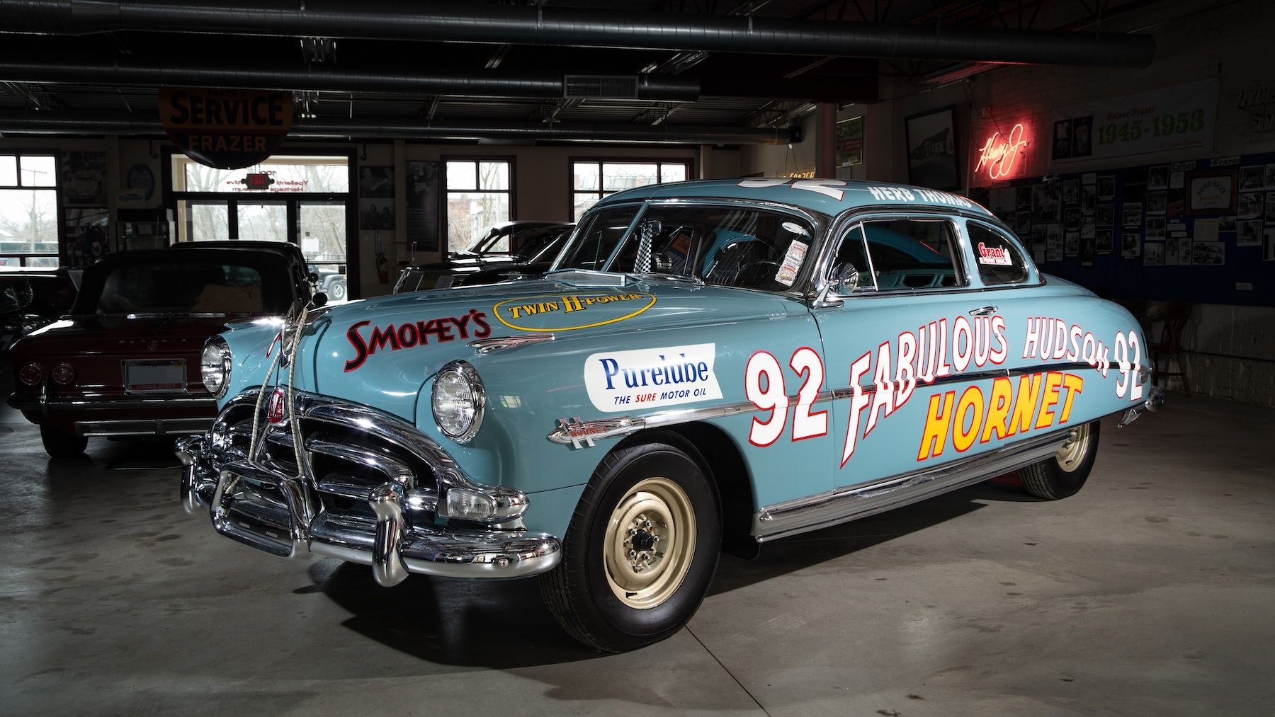 Vintage car with hand-painted lettering on its livery.