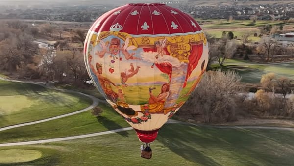 Photo from from the air of a hot air balloon hand-painted with Renaissance-inspired art.