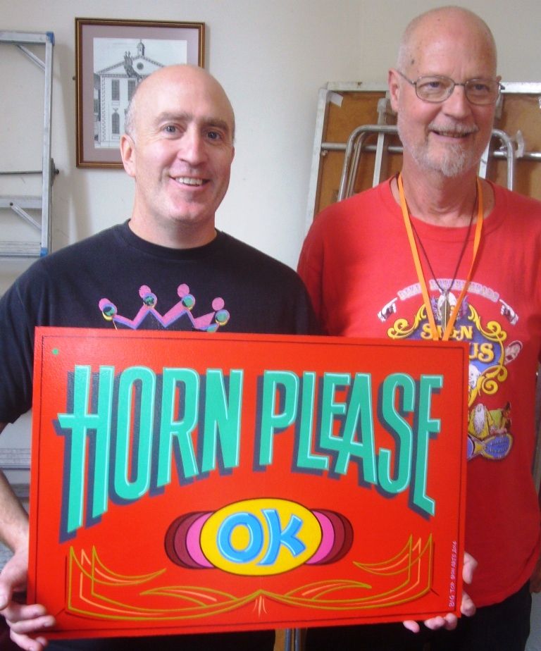 Dan shows off his Horn Please panel, a John Lenning original, after bidding for it in the auction.