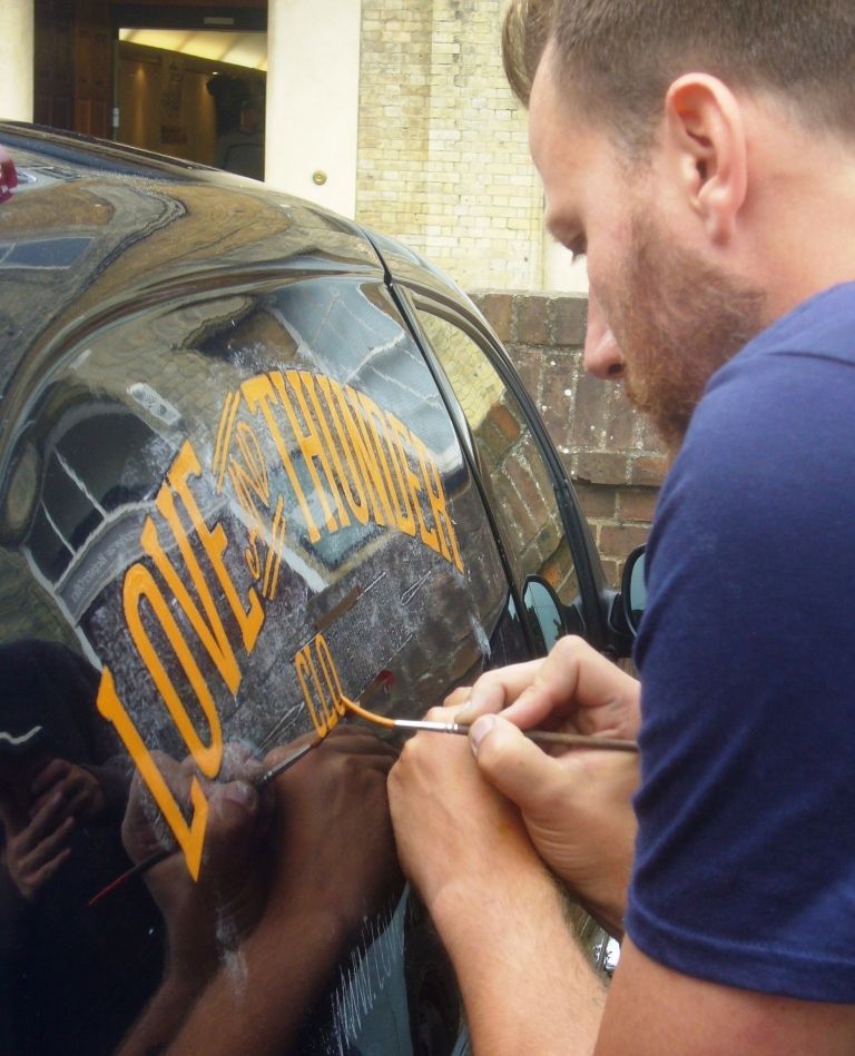 Jasper lettering the Love & Thunder van.