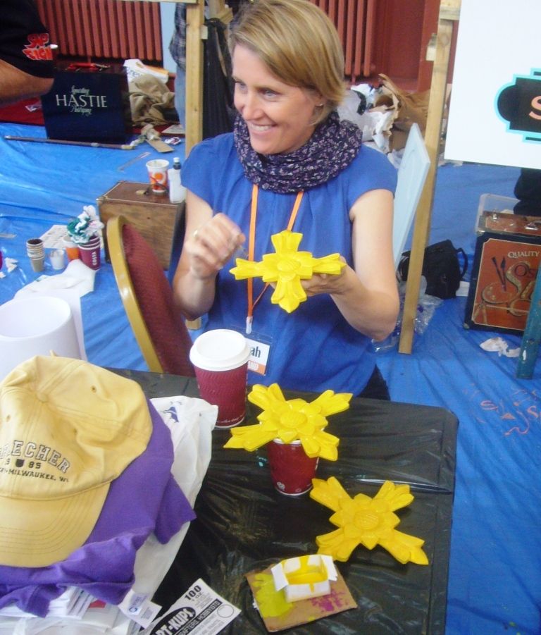 Sarah Bishop applying size ahead of gilding these caravan decorations.