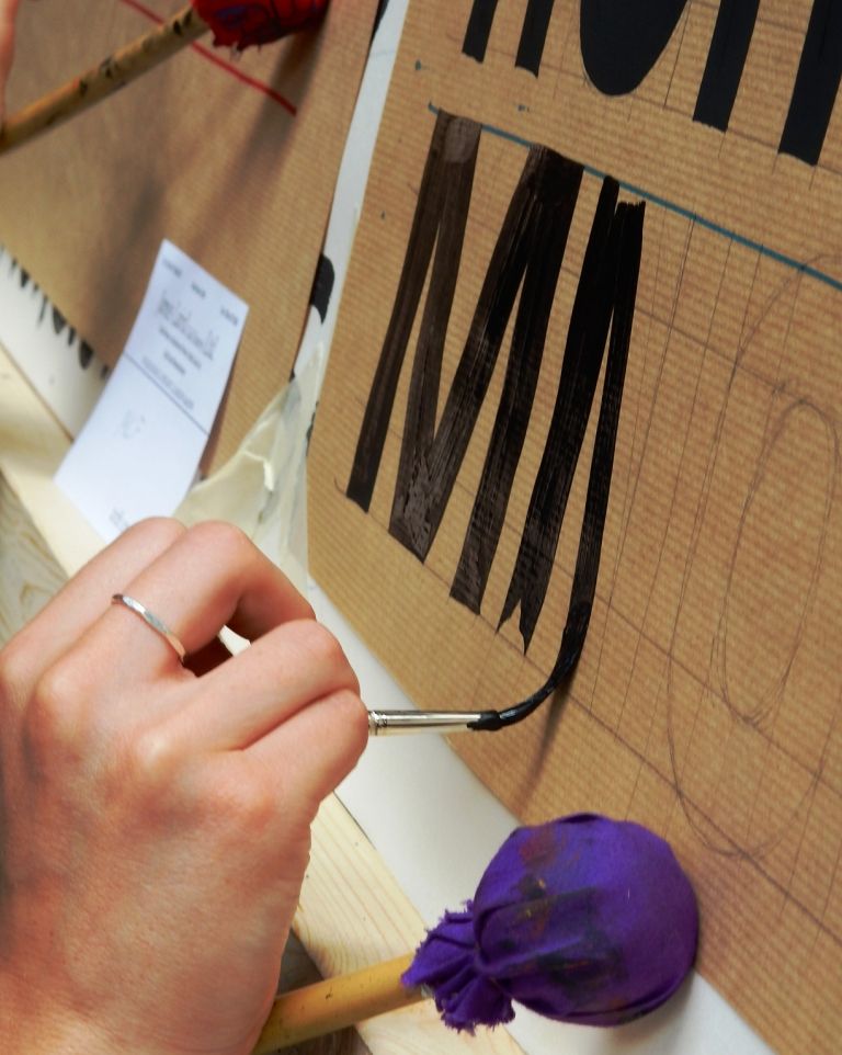 Mahl stick resting on the easel, brush to a chisel edge, and pull