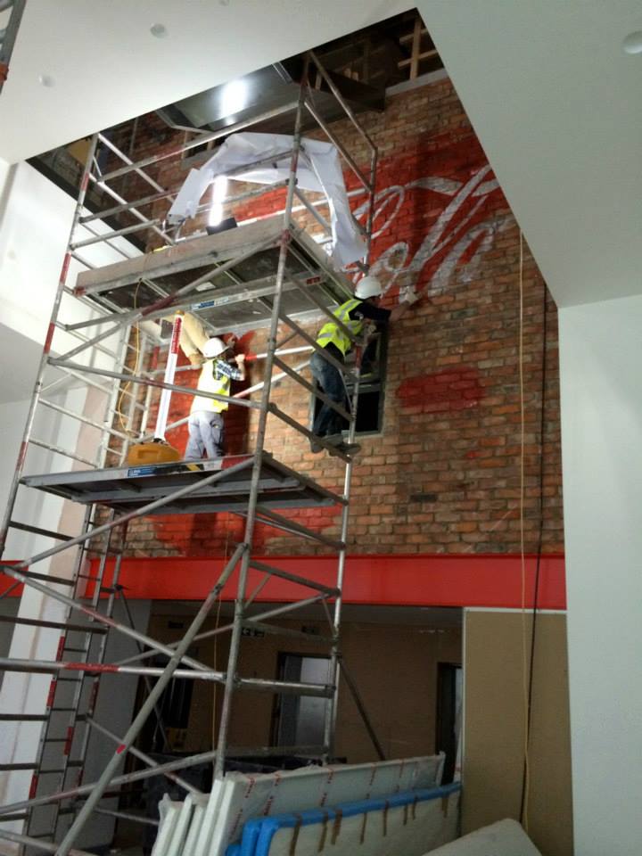 At work on the faux ghostsigns for Coca-Cola (Photo: acrylicize / Nikhilesh Haval)