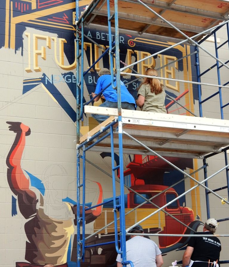 Painting underway on one of the four large-scale murals painted for the museum at the meet.