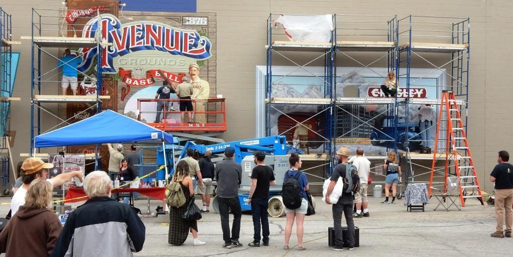 The scene outside the American Sign Museum as work is in full swing on the four large-scale murals being painted.