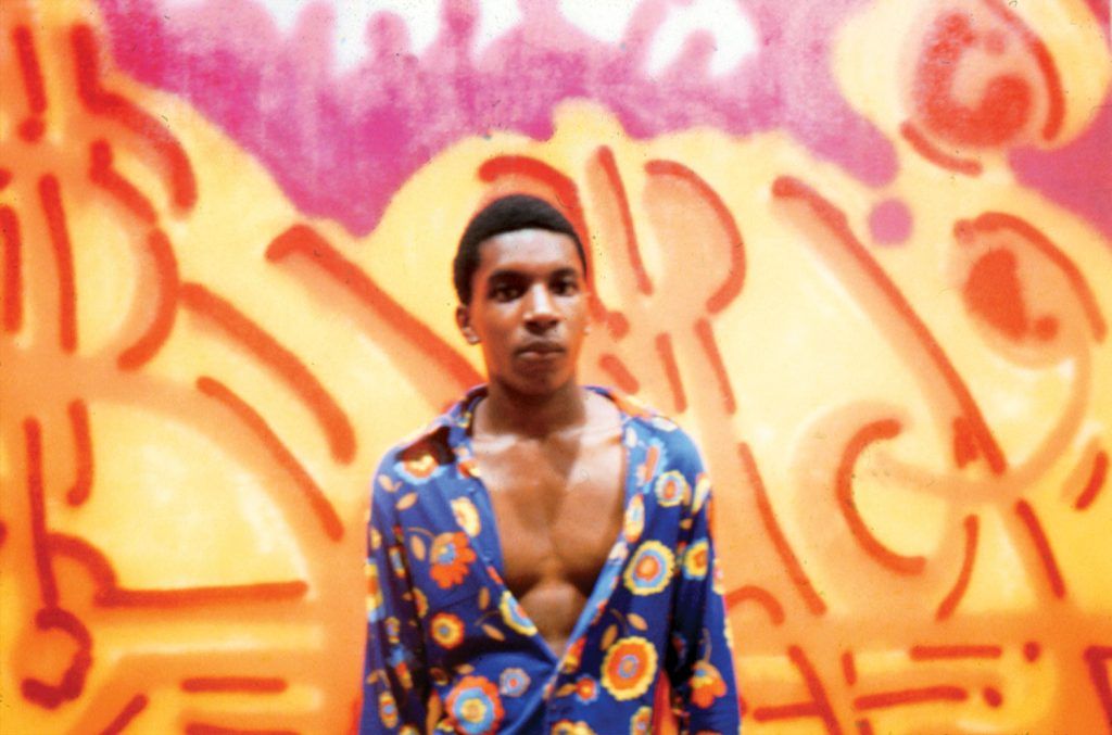BAMA poses in front of his painting “Orange Juice” at the Razor Gallery. 1973.Photos by Herbert Migdoll.