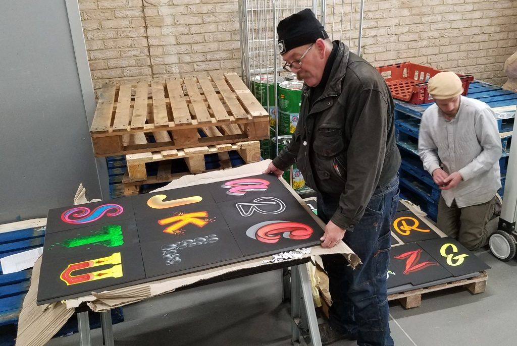 Mike Meyer, Sign Painter, and Tom Graham mounting letters for back panels of the peep show.