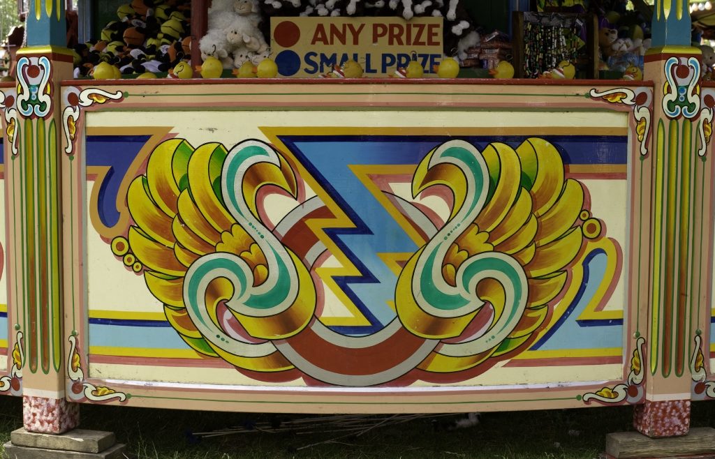 Detail of hand-painted panel with decorative fairground art.