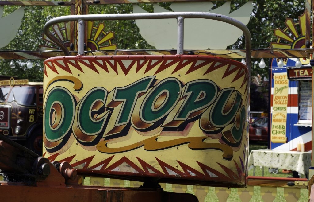 Hand-painted fairground art and lettering with the word 'Octopus'.