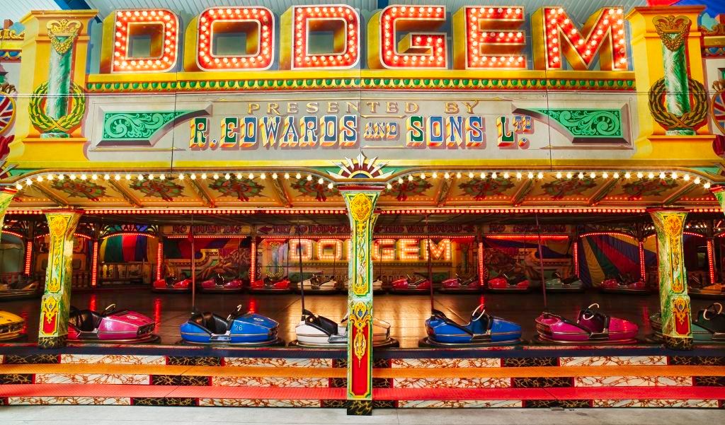 Flamboyant fairground art and lettering, painted and illuminated, for a dodgems ride.