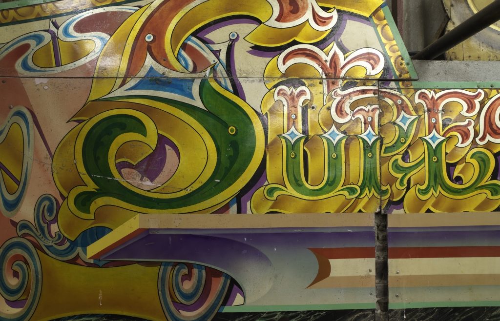 Detail of highly decorative hand-painted fairground art and lettering.