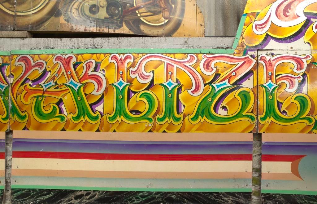 Detail of highly decorative hand-painted fairground art and lettering.