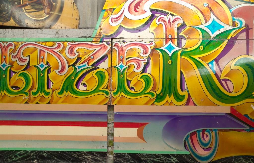 Detail of highly decorative hand-painted fairground art and lettering.