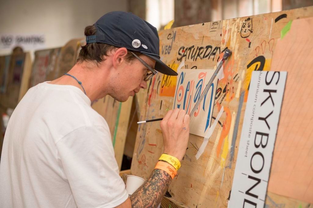 Simon Travis (Brush & Leaf) working on a panel swap for Copenhagen Signs.