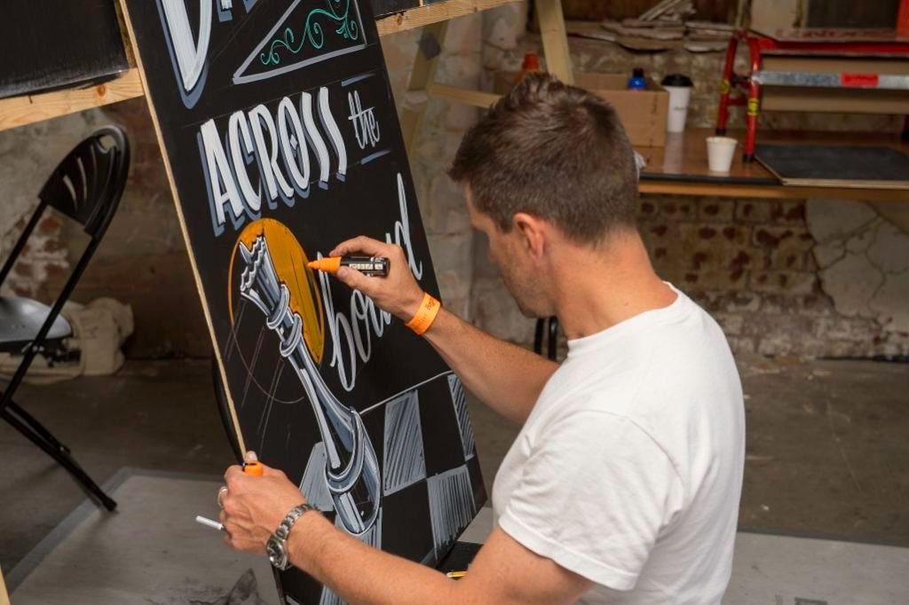 The bar area also hosted a series of demonstrations, seminars and short workshops. Here Nathan Collis (Mucha Muckle) puts the finishing touches to a large blackboard following his session.