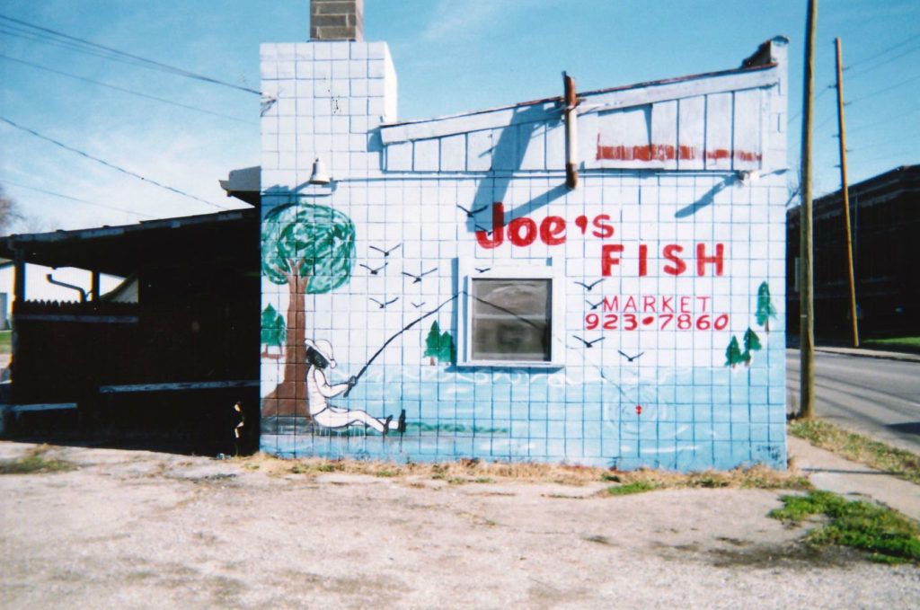 Lettering and pictorial work on a side wall.