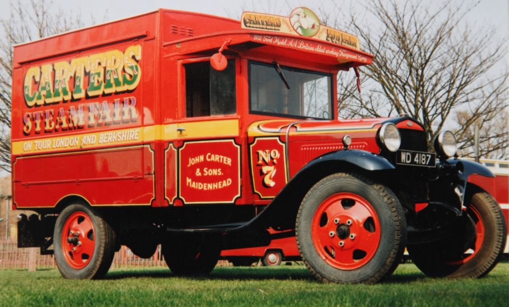 Vintage truck with hand-painted lettering advertising Carters Steam Fair.