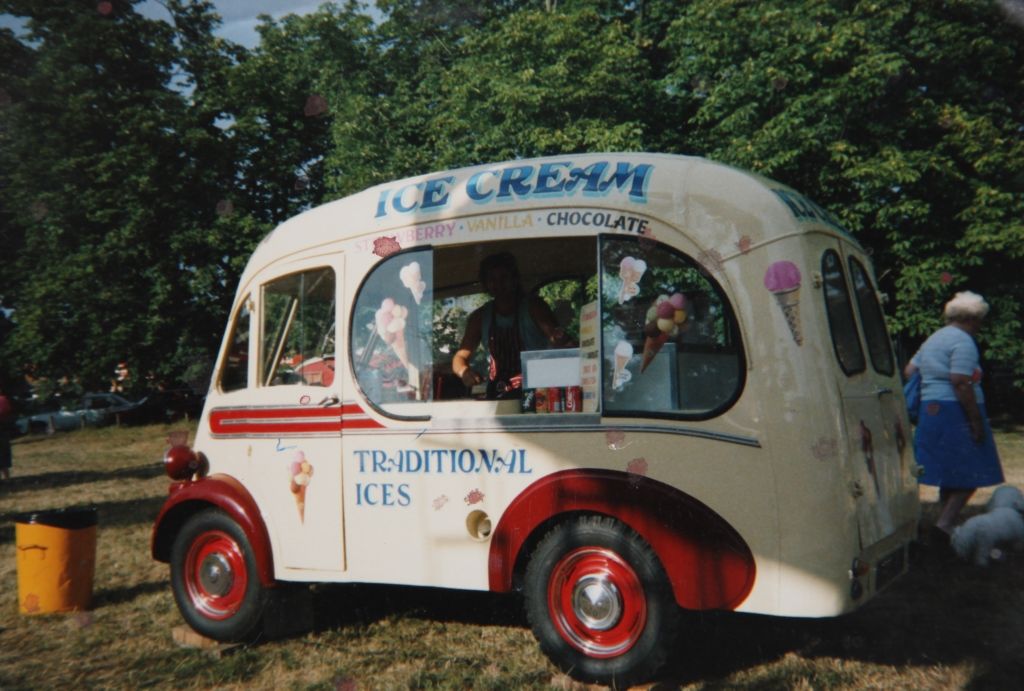 Vintage ice cream van decorated with hand-painted lettering and illustrations.