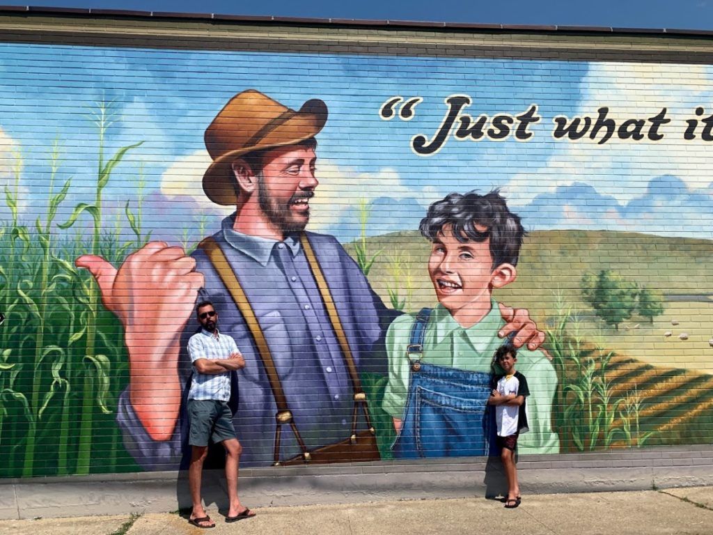 Mark Oatis’ son-in-law and grandson in front of the pictorials modeled on them.